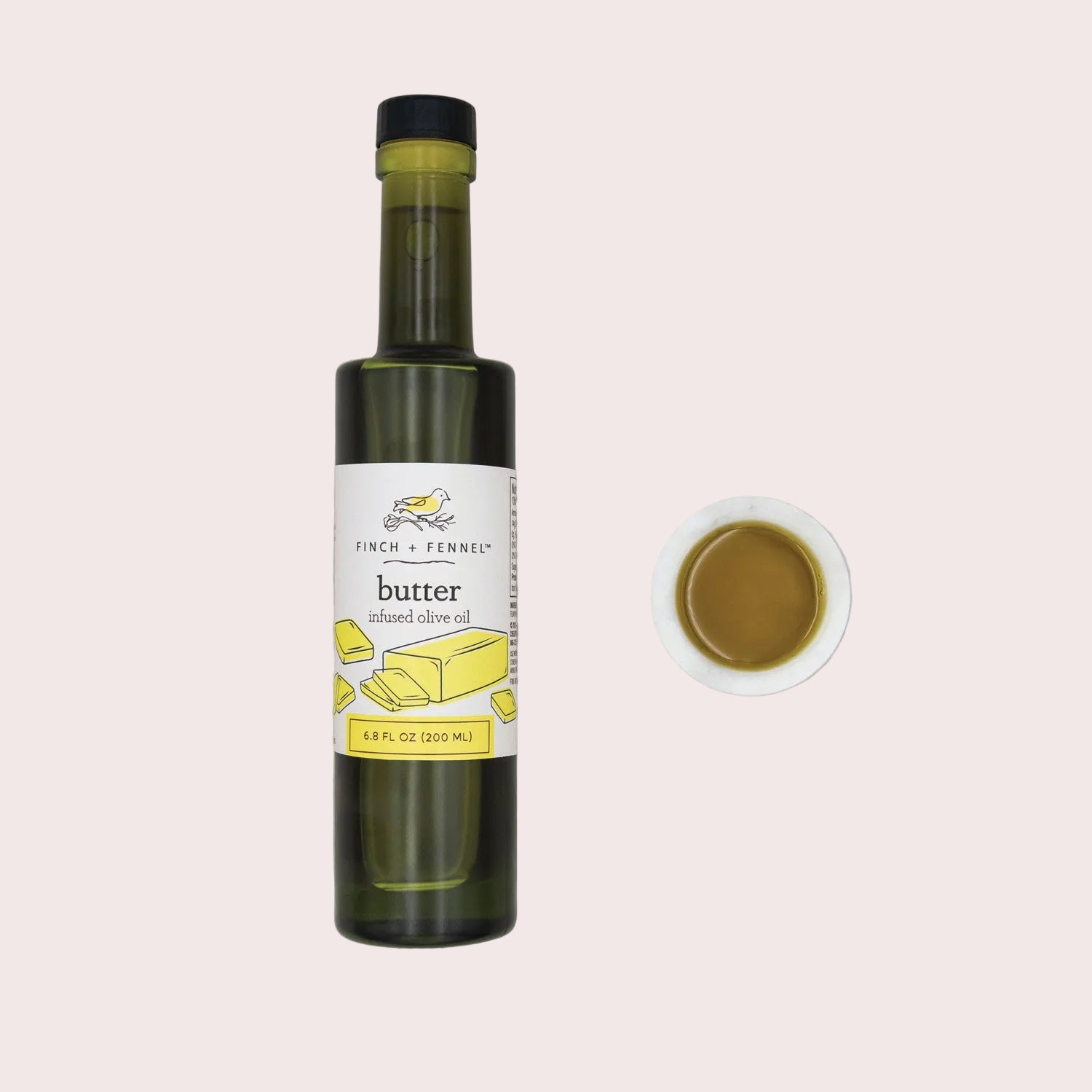 Bottle of Finch + Ferned butter infused olive oil on a light gray background