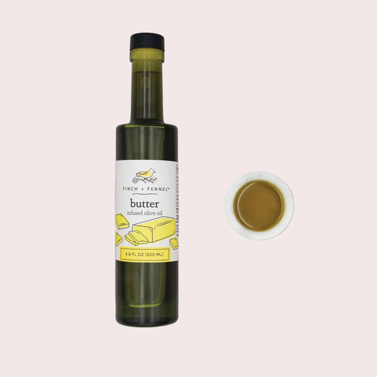 Bottle of Finch + Ferned butter infused olive oil on a light gray background