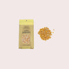 Jumbo popcorn package with unpopped kernels on a light gray background