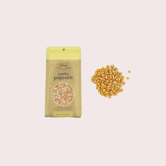 Jumbo popcorn package with unpopped kernels on a light gray background