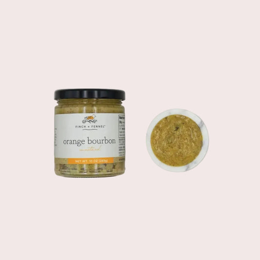 Jar of 'Orange Bourbon' mustard with a spoonful on a textured gray background