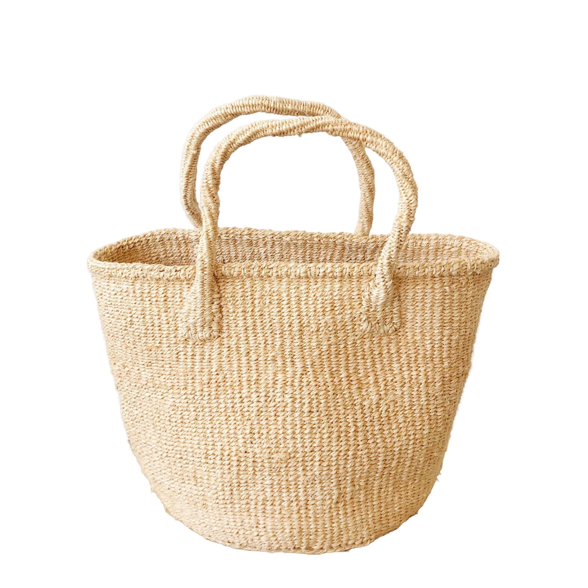 Woven basket with handles on a wooden stool against a white wall.